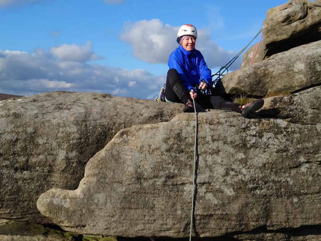 A club member climbing on the gritstone